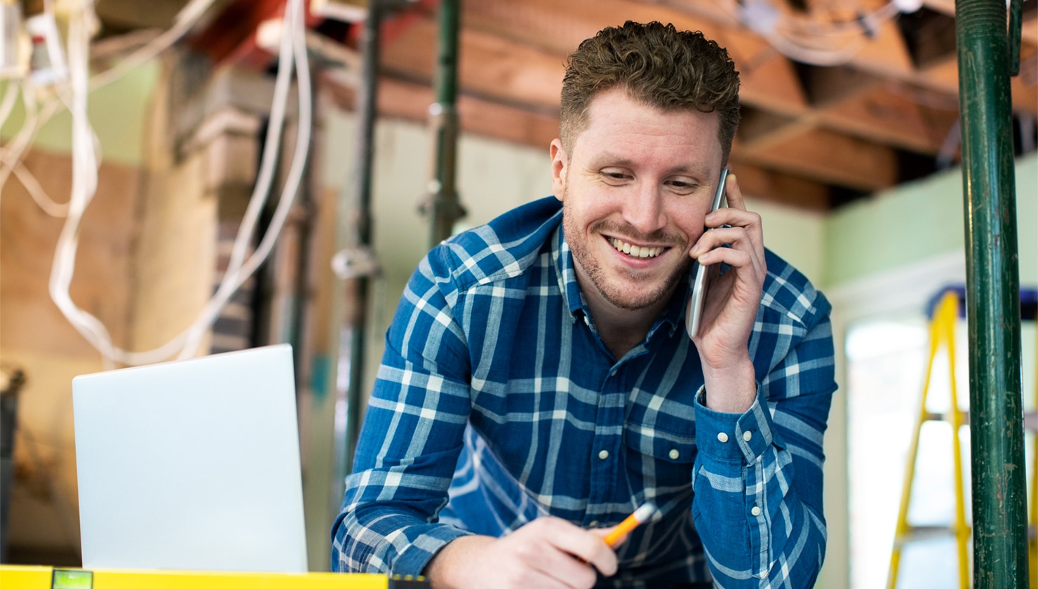 working man talking on the phone on construction site