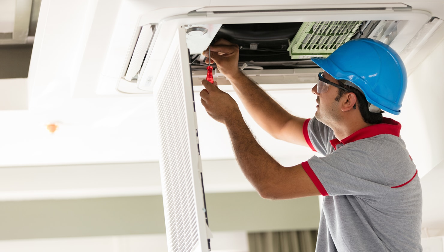 male hvac tech working on vent