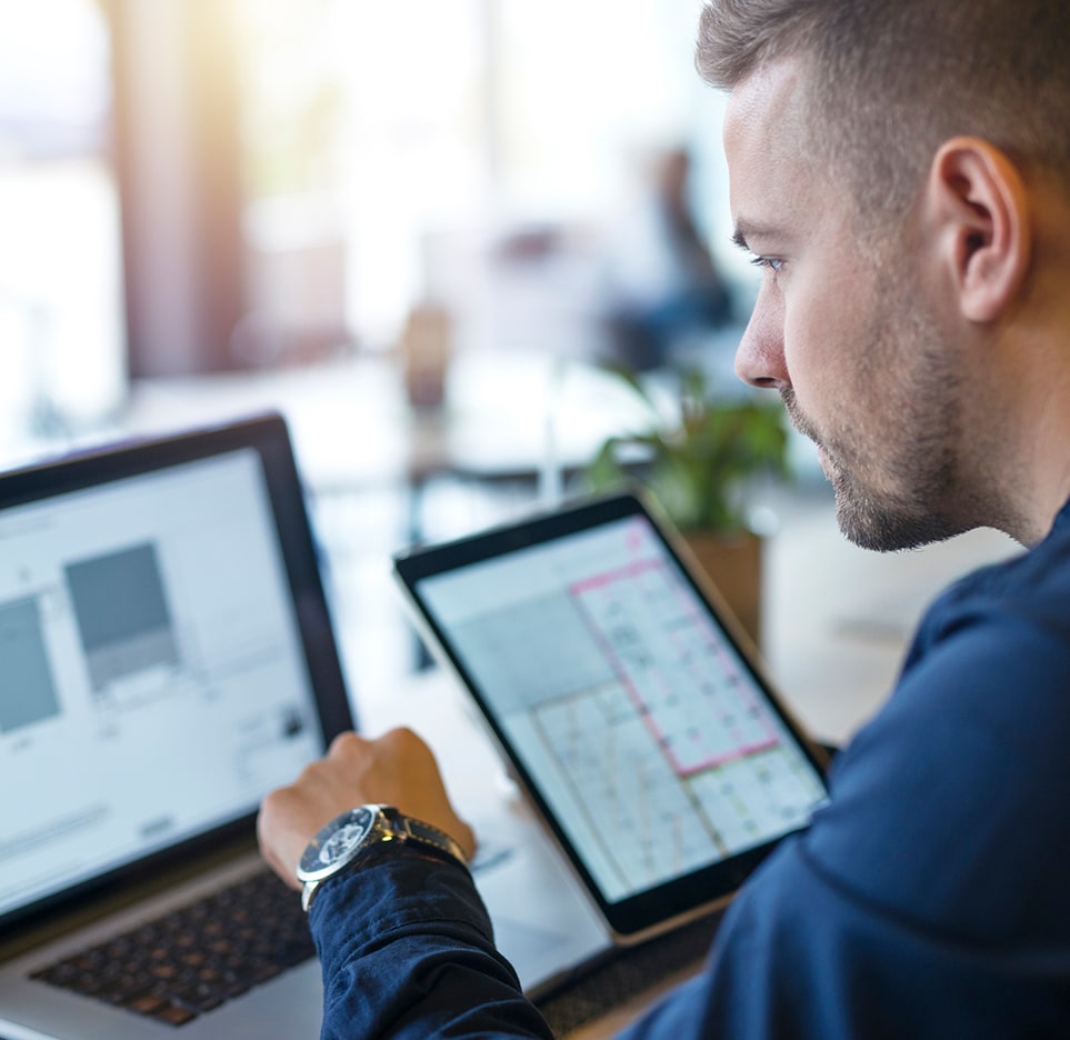 young male worker with tablet and computer