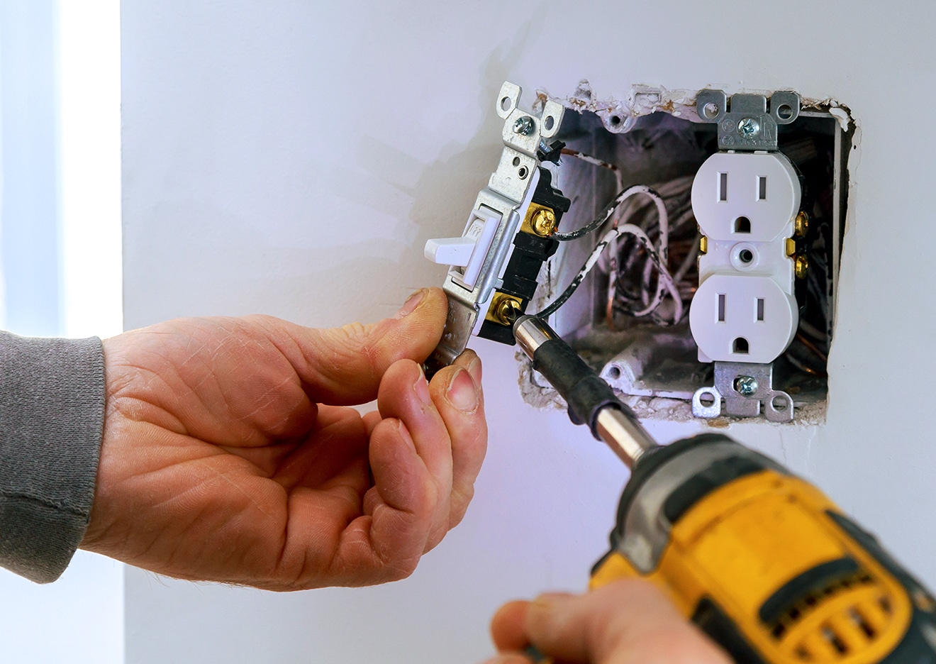 electrician working on outlets indoors