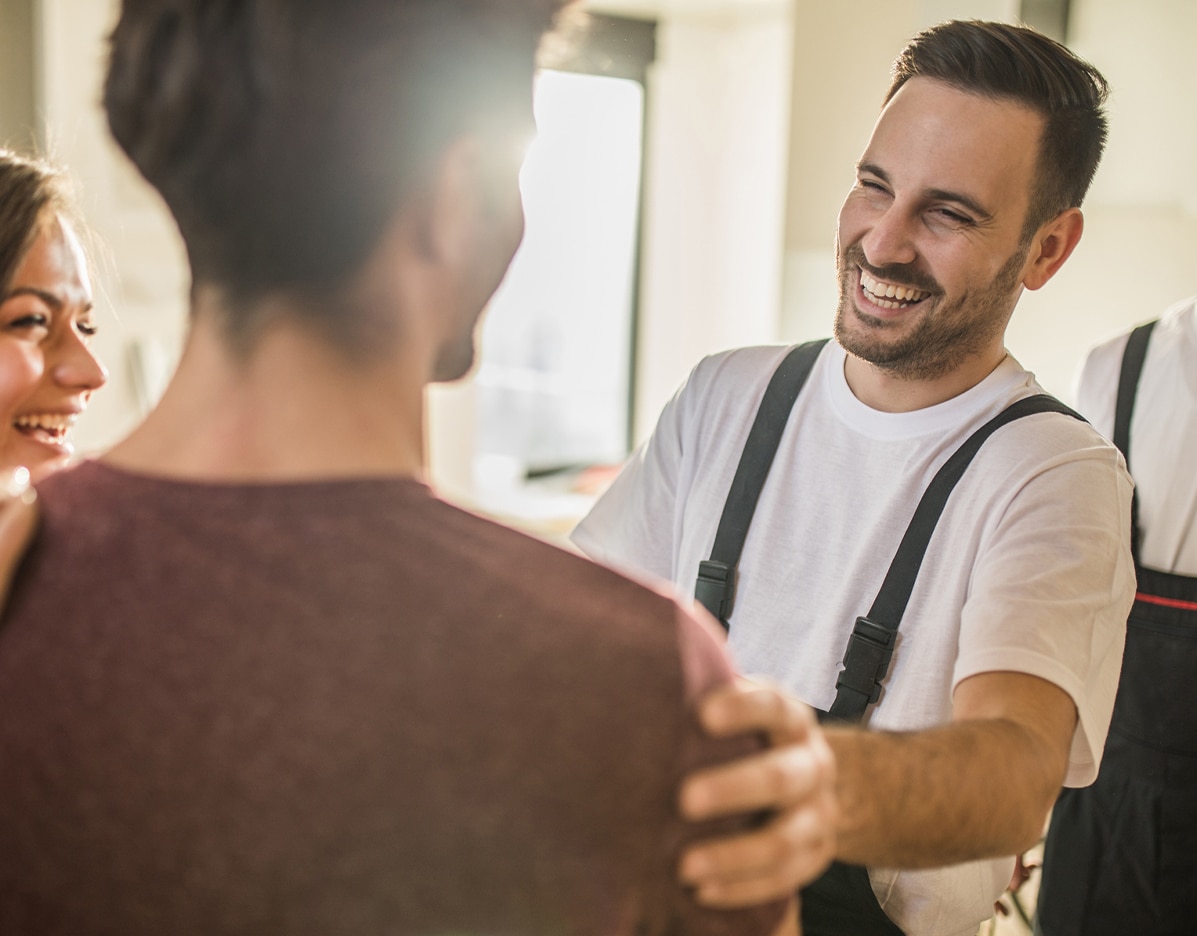 smiling field service tech with smiling customers